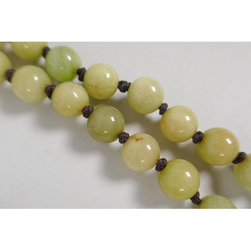 616 - A celadon jade bead necklace, 120cm