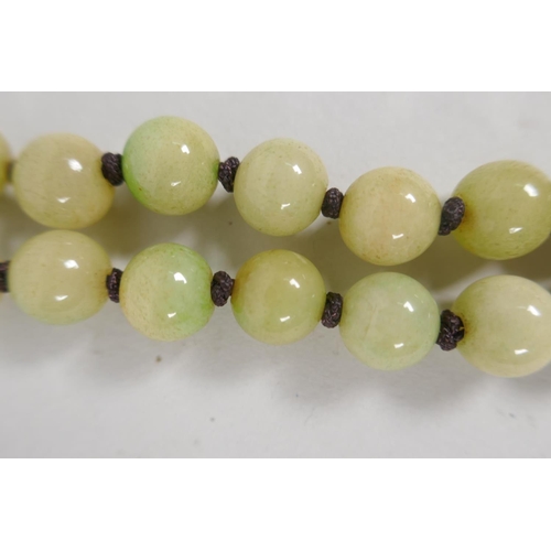 616 - A celadon jade bead necklace, 120cm