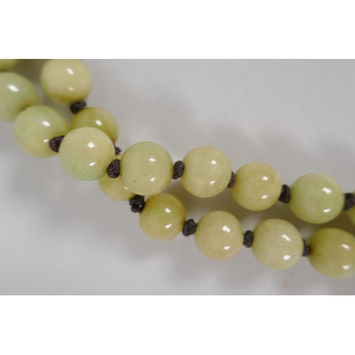 616 - A celadon jade bead necklace, 120cm