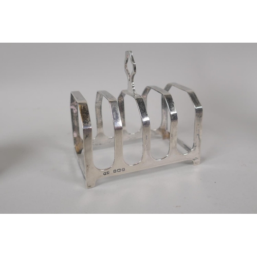 619 - A collection of silver to include a toast rack by Mason and Jones, Birmingham, 1937, 47g; a tea stra... 