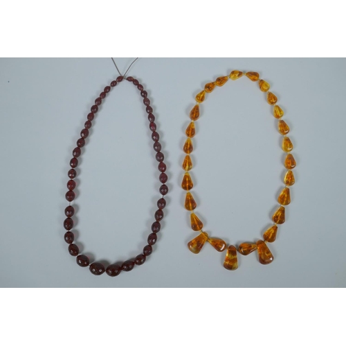 620 - A string of faceted and graduated cherry amber beads, 64g, 68cm, and a Baltic amber graduated bead n... 