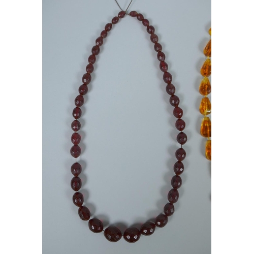 620 - A string of faceted and graduated cherry amber beads, 64g, 68cm, and a Baltic amber graduated bead n... 