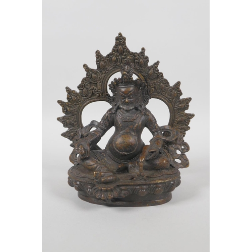 63 - A Tibetan bronze figure of Jambhalia, double vajra mark to base, 17cm high