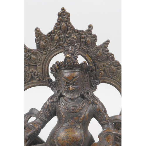 63 - A Tibetan bronze figure of Jambhalia, double vajra mark to base, 17cm high