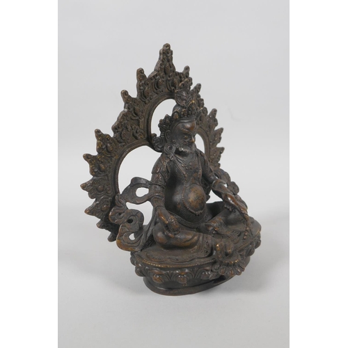 63 - A Tibetan bronze figure of Jambhalia, double vajra mark to base, 17cm high