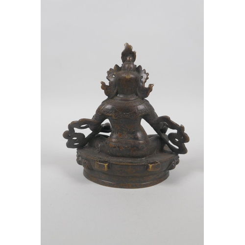 63 - A Tibetan bronze figure of Jambhalia, double vajra mark to base, 17cm high