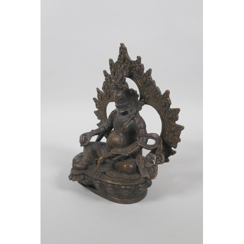 63 - A Tibetan bronze figure of Jambhalia, double vajra mark to base, 17cm high