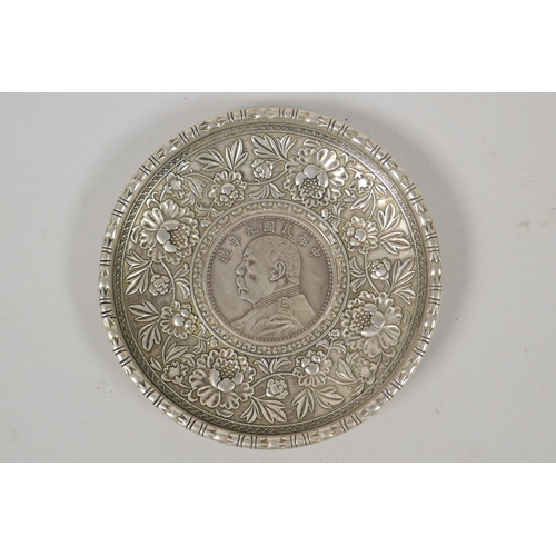 630 - A Chinese white metal coin dish with raised lotus flower decoration, and another similar with bamboo... 