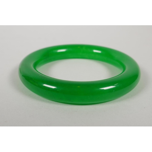 632 - An apple green jade bangle, 8.5cm diameter