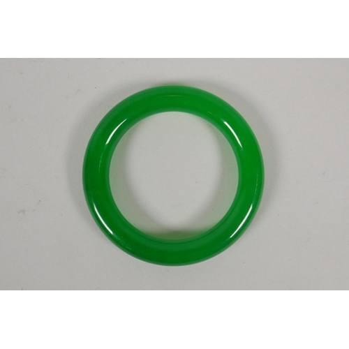 632 - An apple green jade bangle, 8.5cm diameter