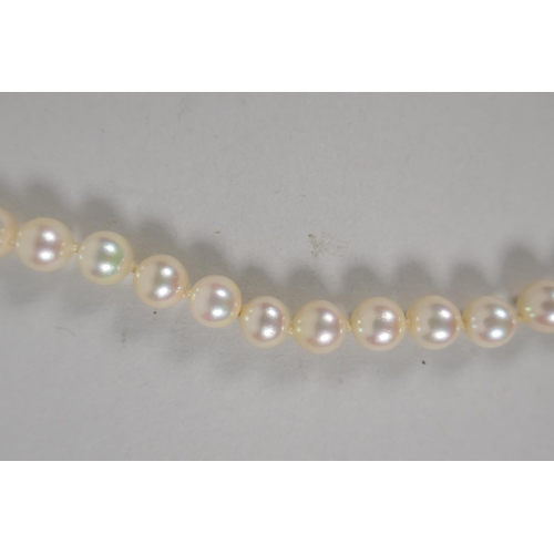 634 - A vintage pearl necklace with a 9ct gold bow shaped clasp, 42cm long