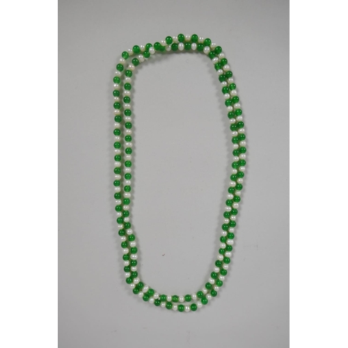 639 - An apple green hardstone and pearl necklace, 116cm long