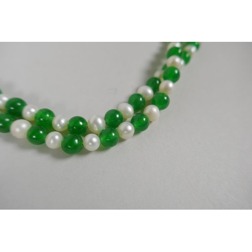 639 - An apple green hardstone and pearl necklace, 116cm long