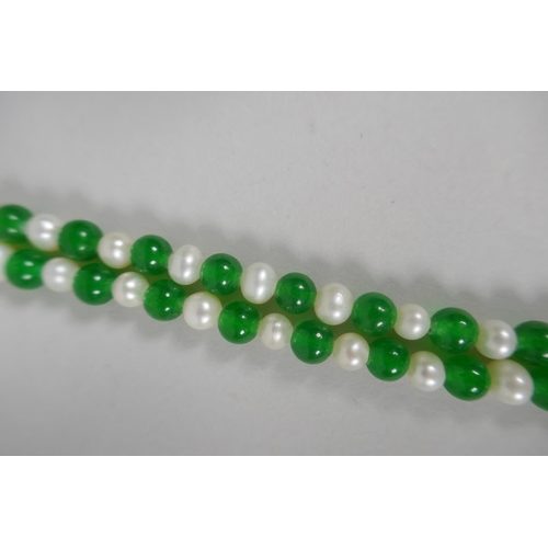 639 - An apple green hardstone and pearl necklace, 116cm long