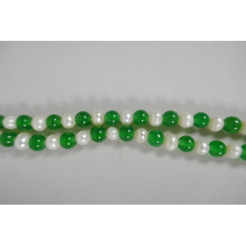 639 - An apple green hardstone and pearl necklace, 116cm long