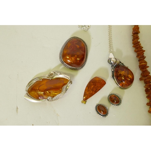 653 - A Baltic amber necklace, 96cm long, another 60cm long, and a silver mounted amber necklace, earrings... 