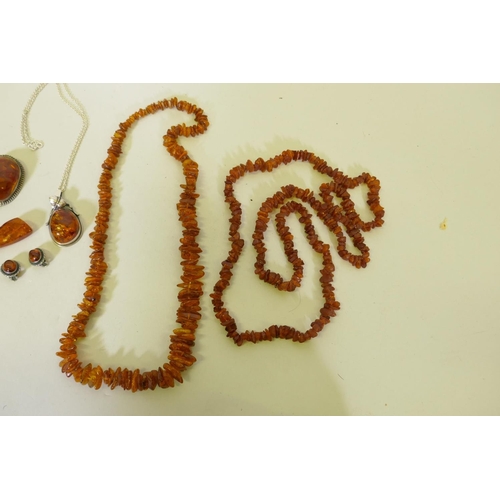 653 - A Baltic amber necklace, 96cm long, another 60cm long, and a silver mounted amber necklace, earrings... 