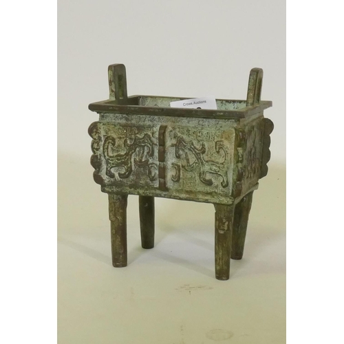 68 - Chinese bronze censer with two handles and archaic style decoration, raised on four supports, 15cm h... 