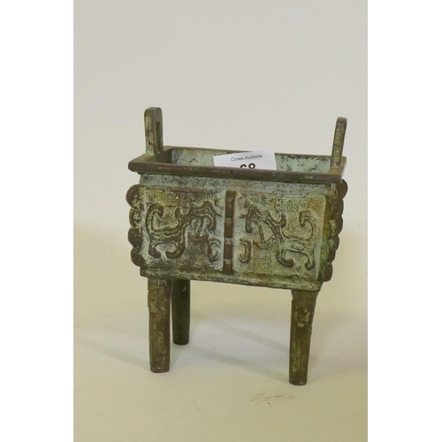 68 - Chinese bronze censer with two handles and archaic style decoration, raised on four supports, 15cm h... 