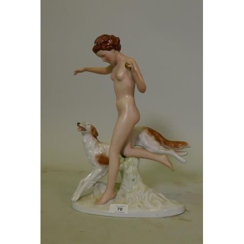 70 - A Bohemian bisque and glazed porcelain figure of a woman with a Borzoi, after the Royal Dux figure o... 