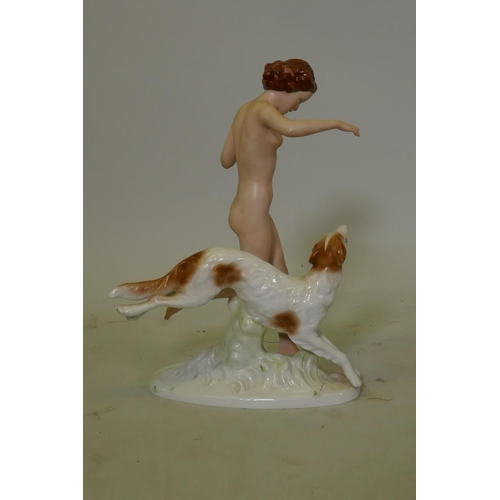 70 - A Bohemian bisque and glazed porcelain figure of a woman with a Borzoi, after the Royal Dux figure o... 