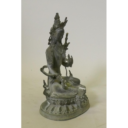 73 - Oriental bronze figure of Buddha seated on a lotus dias, 32cm high