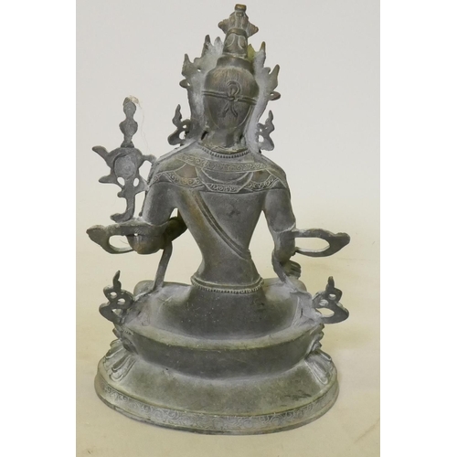 73 - Oriental bronze figure of Buddha seated on a lotus dias, 32cm high