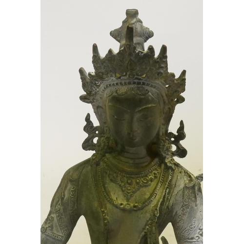 73 - Oriental bronze figure of Buddha seated on a lotus dias, 32cm high