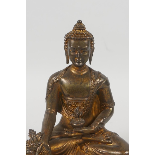 75 - A Tibetan gilt bronze figure of Buddha seated on a lotus throne, double vajra mark to base, 15cm hig... 