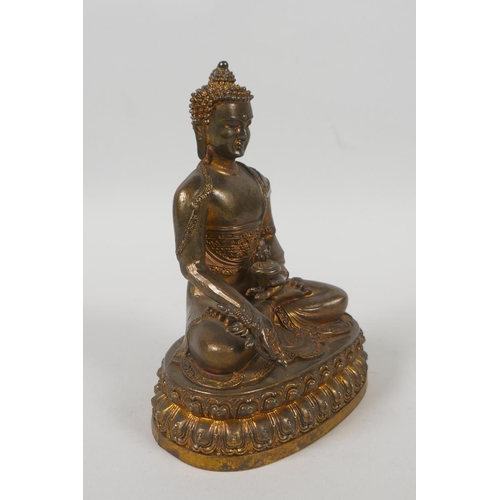 75 - A Tibetan gilt bronze figure of Buddha seated on a lotus throne, double vajra mark to base, 15cm hig... 