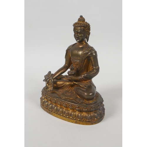 75 - A Tibetan gilt bronze figure of Buddha seated on a lotus throne, double vajra mark to base, 15cm hig... 