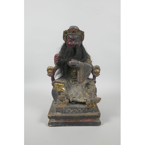 83 - A Chinese carved and painted wood figure of a bearded immortal with gilt highlights, 28cm high