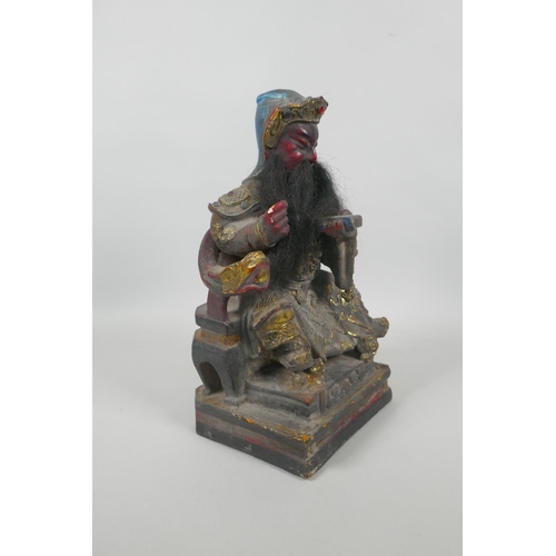 83 - A Chinese carved and painted wood figure of a bearded immortal with gilt highlights, 28cm high