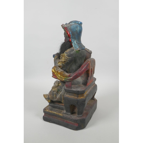 83 - A Chinese carved and painted wood figure of a bearded immortal with gilt highlights, 28cm high