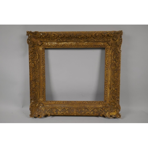 880 - An C18th carved giltwood picture frame with C scroll decoration, rebate 32 x 35cm