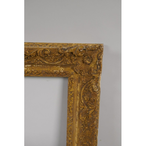 880 - An C18th carved giltwood picture frame with C scroll decoration, rebate 32 x 35cm