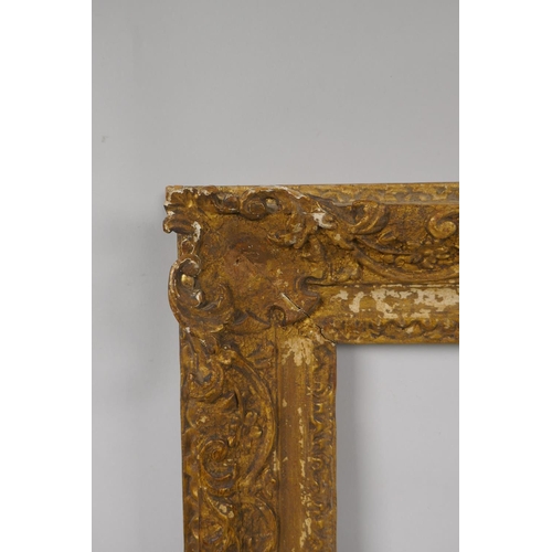 880 - An C18th carved giltwood picture frame with C scroll decoration, rebate 32 x 35cm