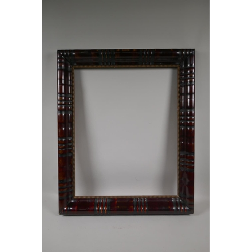 887 - An early C20th Dutch style ebonised and burnished picture frame with reeded decoration, 58 x 47cm