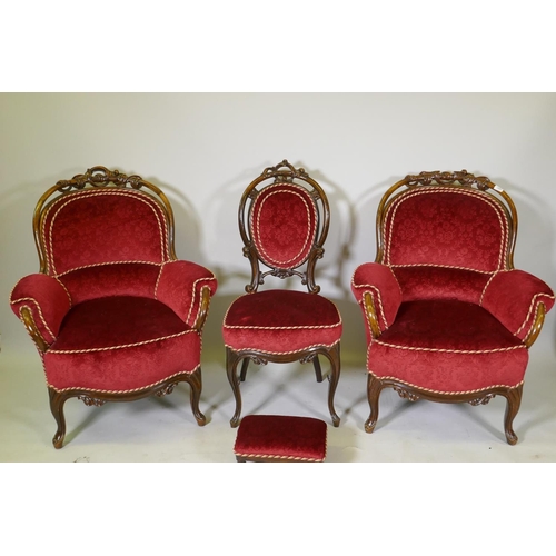 1113 - A pair of Victorian show frame walnut arm chairs, with carved and pierced backs, raised on shaped su... 