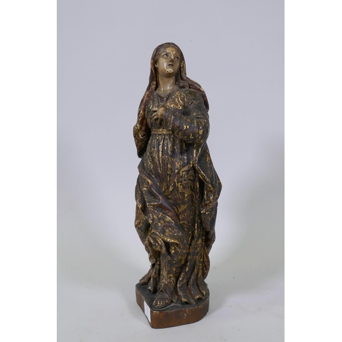 1 - A carved limewood figure of the Virgin Mary with polychrome and parcel gilt decoration and glass eye... 