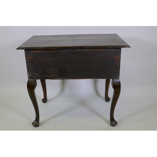 1001 - A Georgian walnut lowboy, the quarter veneered top with moulded edge and cut corners with herringbon... 