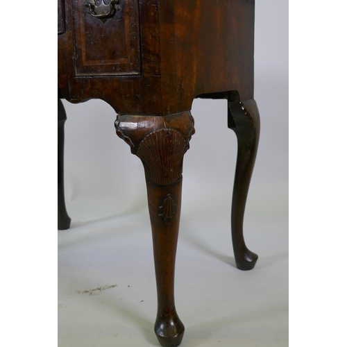 1001 - A Georgian walnut lowboy, the quarter veneered top with moulded edge and cut corners with herringbon... 