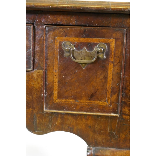 1001 - A Georgian walnut lowboy, the quarter veneered top with moulded edge and cut corners with herringbon... 