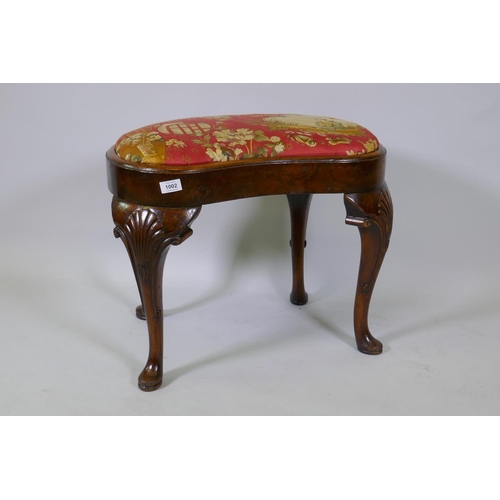 1002 - Georgian style walnut veneered kidney shaped foot stool, with drop in seat, raised on carved cabriol... 