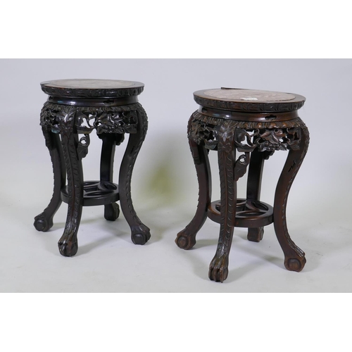 1004 - A pair of antique Chinese hardwood stands with inset rouge marble tops and carved and pierced frieze... 