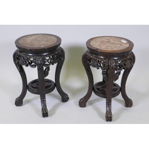 1004 - A pair of antique Chinese hardwood stands with inset rouge marble tops and carved and pierced frieze... 