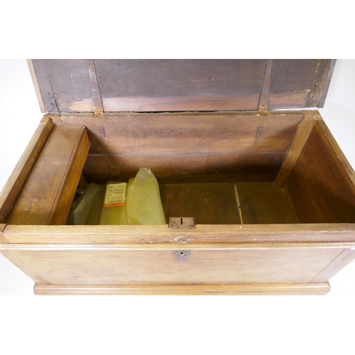 1006 - A C19th Dutch colonial padouk wood coffer, the interior fitted with a candle box, raised on turned f... 