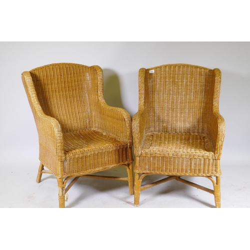 1008 - A pair of cane conservatory arm chairs