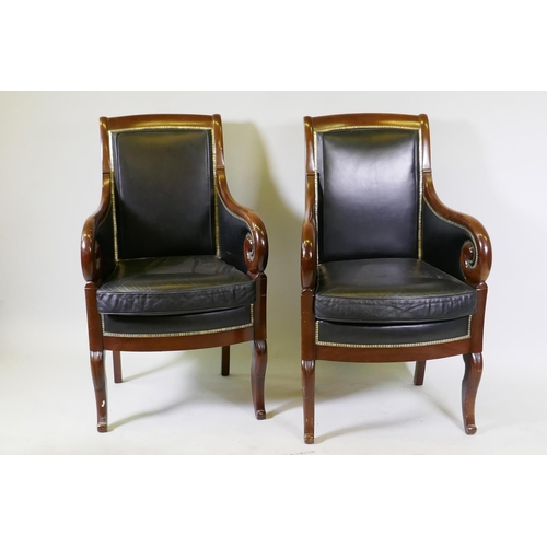 1014 - A pair of French Empire style mahogany framed armchairs, upholstered in leather