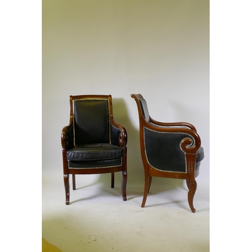 1014 - A pair of French Empire style mahogany framed armchairs, upholstered in leather